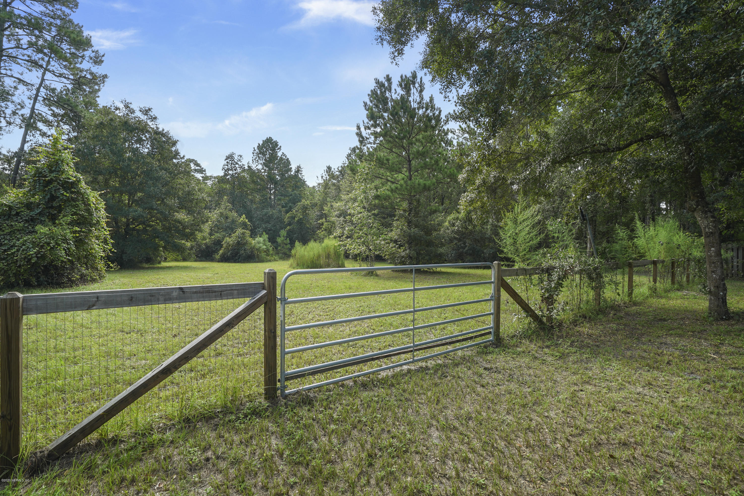 1435 Long Bay Road Middleburg, FL 32068 - Photo 4 of 27 a view of a green field with wooden fence