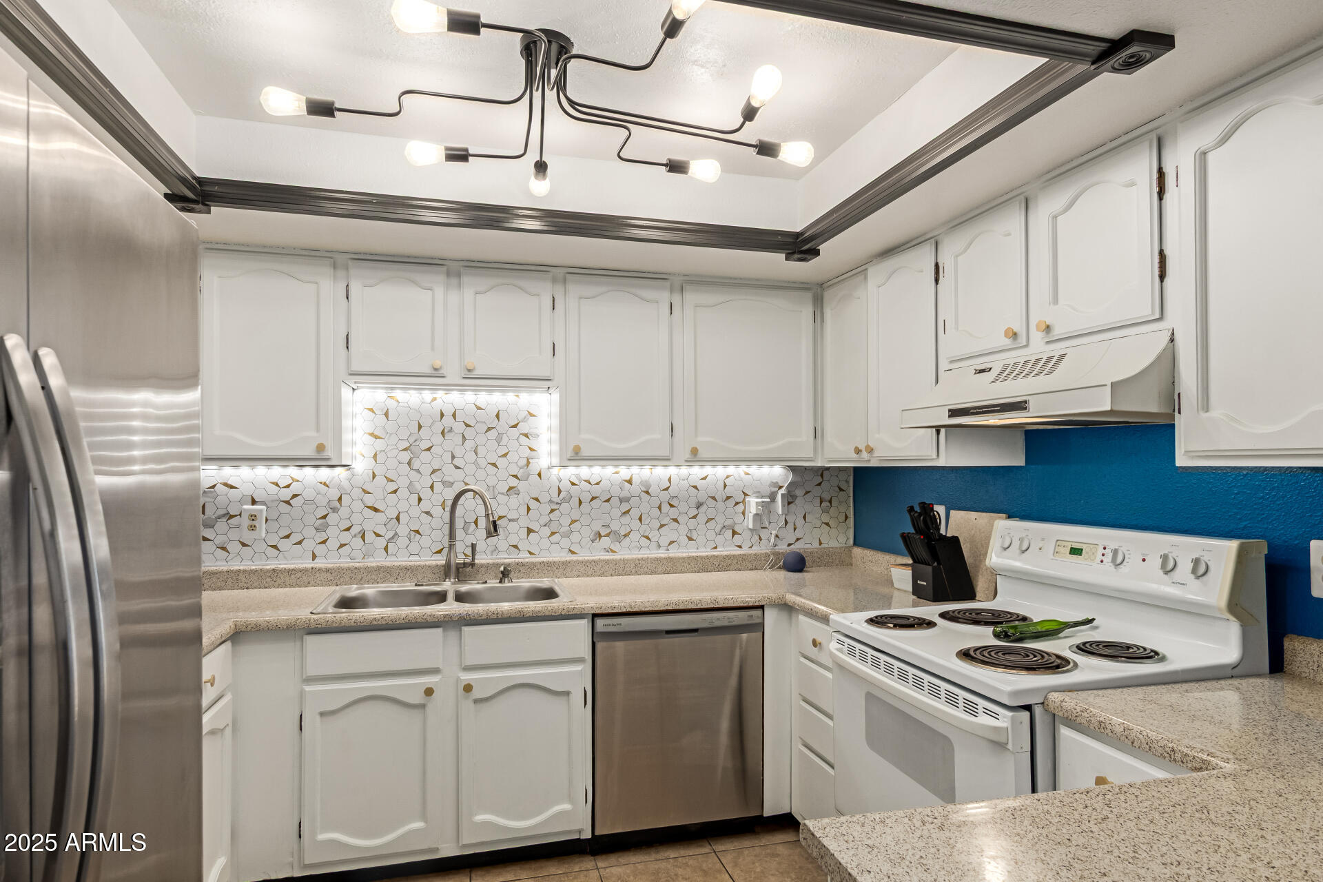 1051 South Dobson Road, Unit 138 Mesa, AZ 85202 - Photo 11 of 28 a kitchen with stainless steel appliances granite countertop a sink a stove and refrigerator