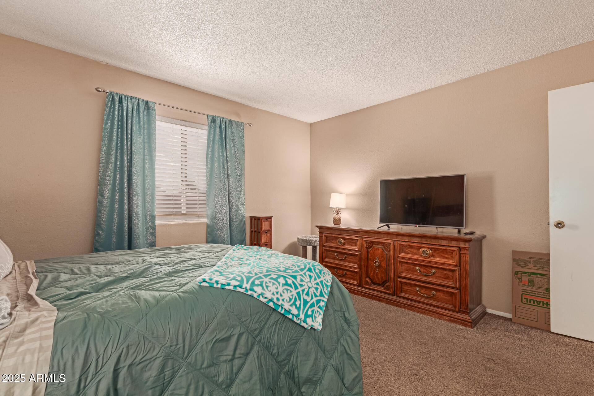 1051 South Dobson Road, Unit 138 Mesa, AZ 85202 - Photo 14 of 28 a bedroom with a bed and flat screen tv