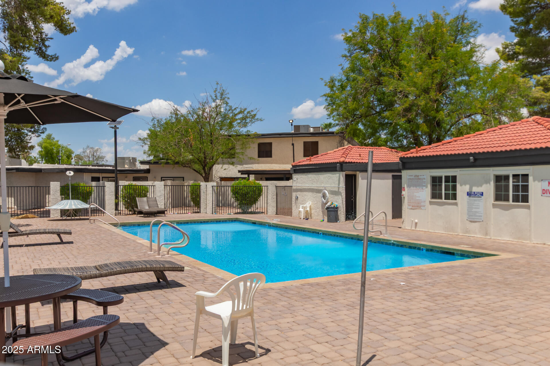 1051 South Dobson Road, Unit 138 Mesa, AZ 85202 - Photo 25 of 28 a view of a house with pool fire pit tables and chairs