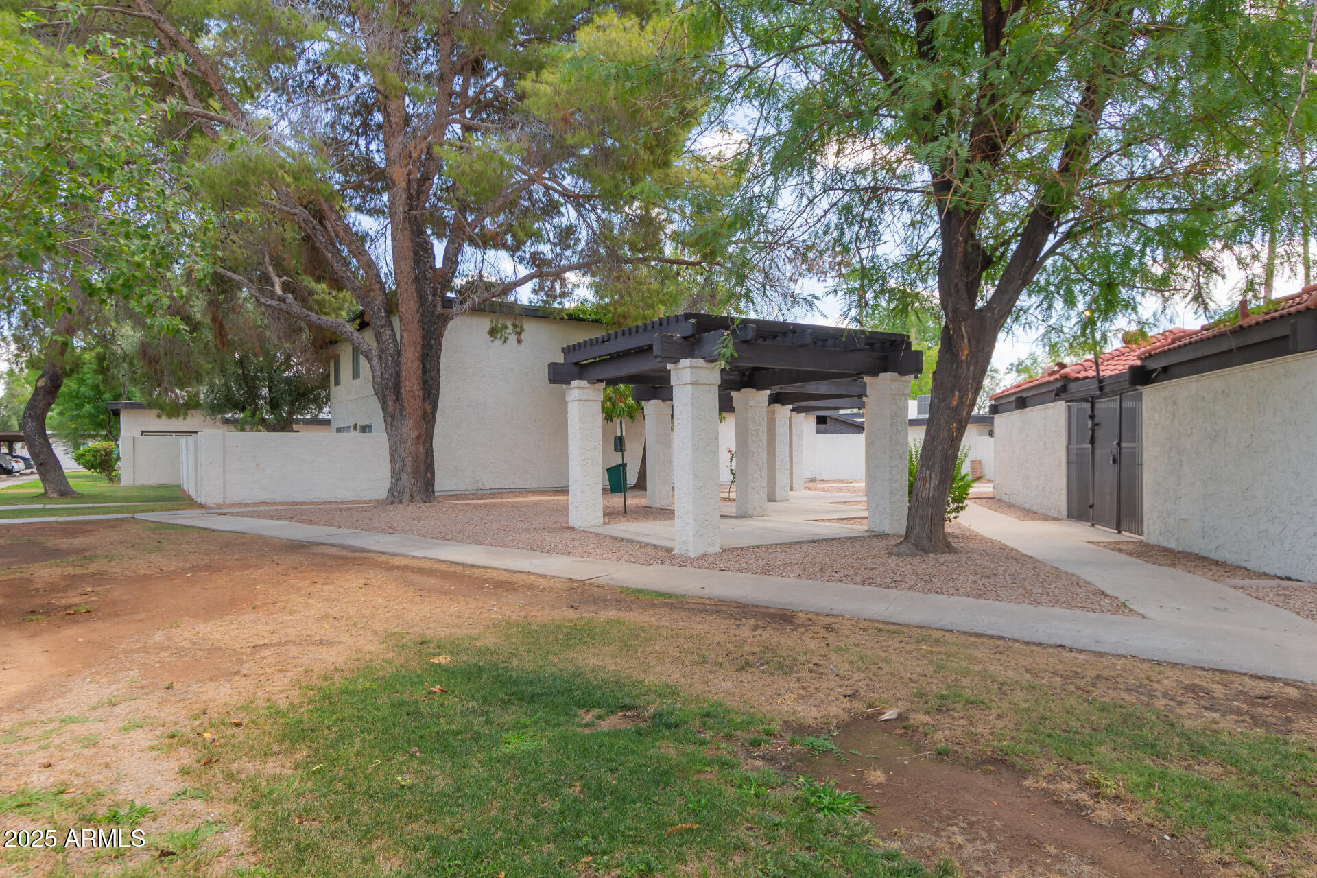 1051 South Dobson Road, Unit 138 Mesa, AZ 85202 - Photo 28 of 28 a view of a house with a tree and a yard