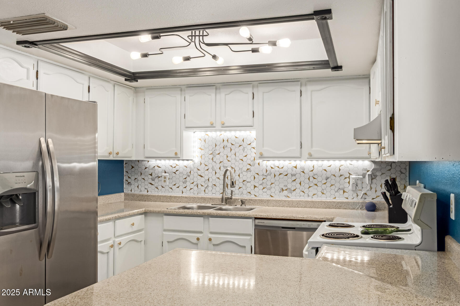1051 South Dobson Road, Unit 138 Mesa, AZ 85202 - Photo 9 of 28 a kitchen with stainless steel appliances granite countertop a sink stove and refrigerator