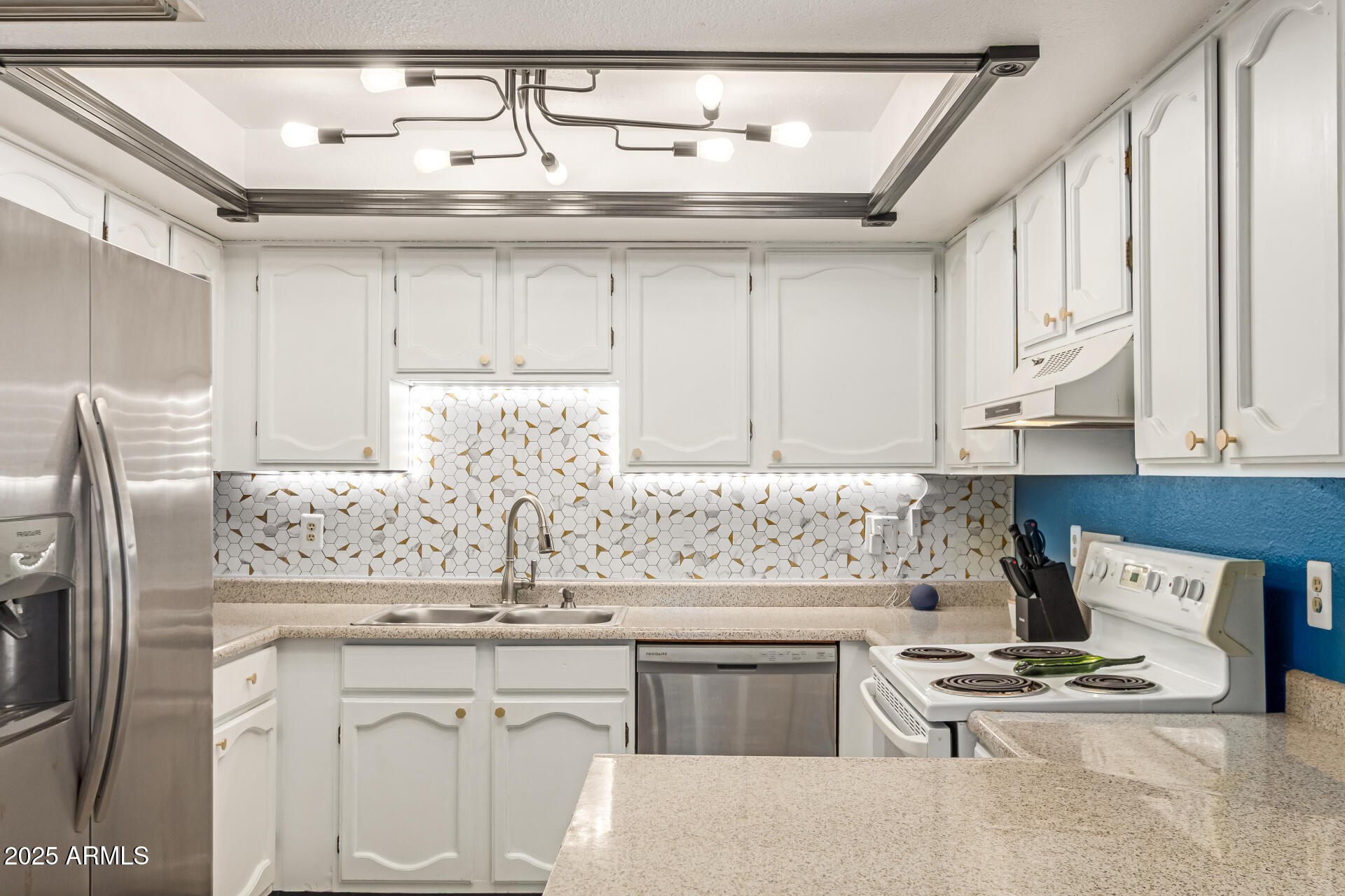 1051 South Dobson Road, Unit 138 Mesa, AZ 85202 - Photo 10 of 28 a kitchen with stainless steel appliances kitchen island granite countertop a sink stove and refrigerator