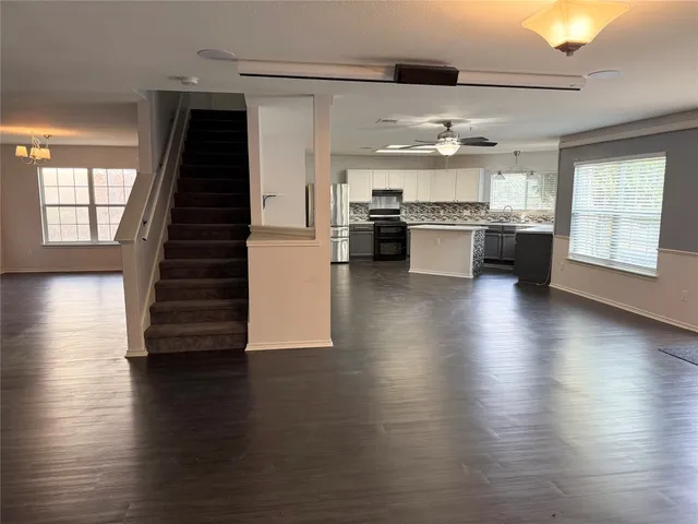 a kitchen with stainless steel appliances a stove and wooden floor
