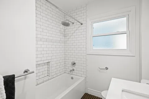 a bathroom with a bathtub and window