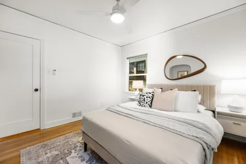 a bedroom with a bed and a chandelier