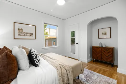 a bedroom with a bed and a couch