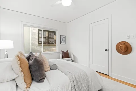 a bedroom with a bed and a window