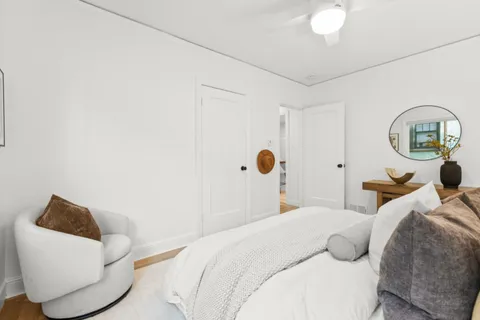 a bedroom with a bed and a painting on the wall