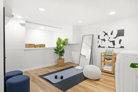 a living room with furniture and flowers