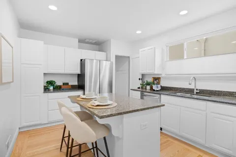 a kitchen with stainless steel appliances granite countertop a sink and cabinets