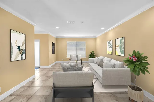 a living room with furniture and a potted plant