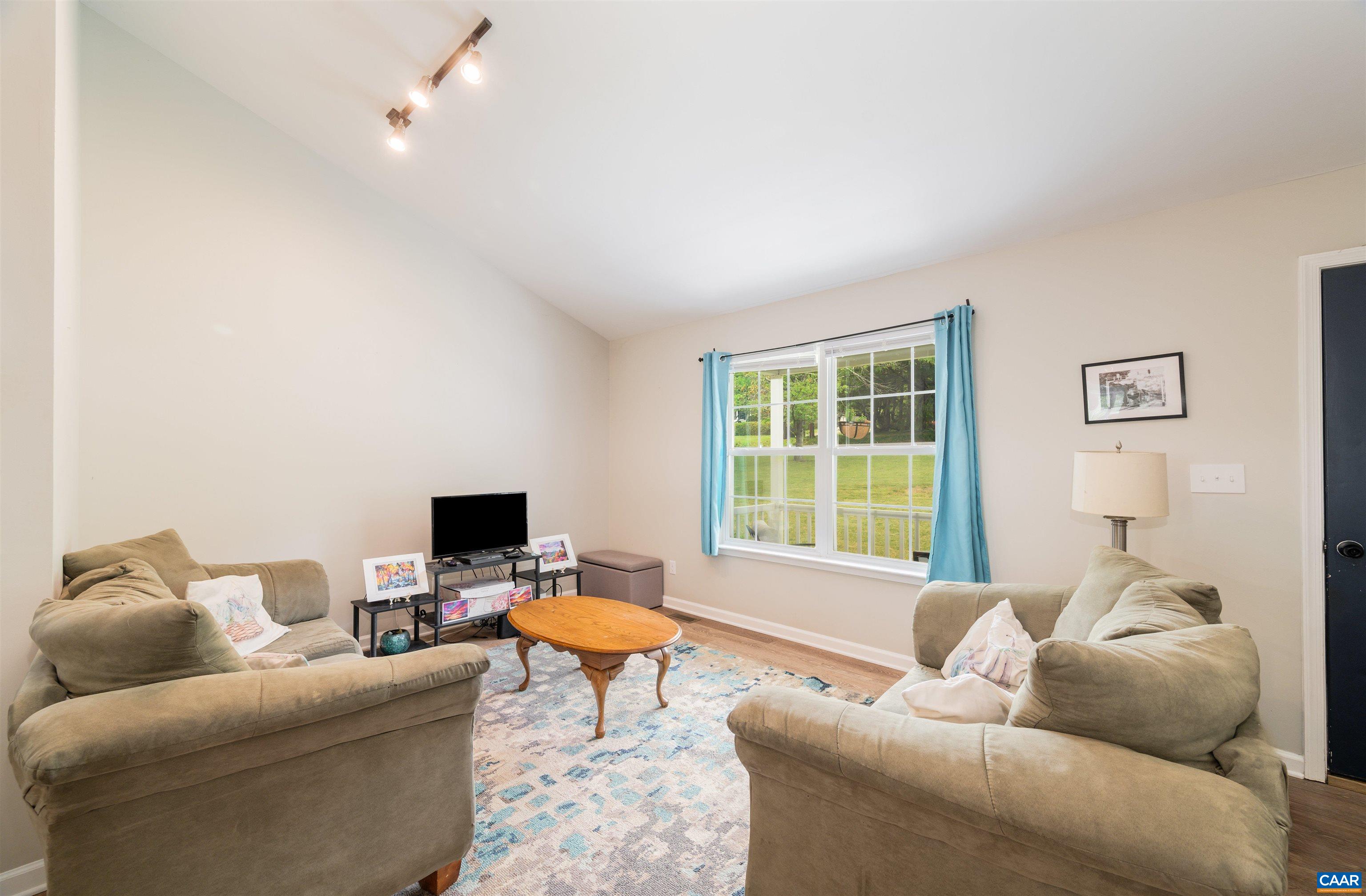 1507 Buck Road Crozet, VA 22932 - Photo 6 of 33 a living room with furniture and a flat screen tv