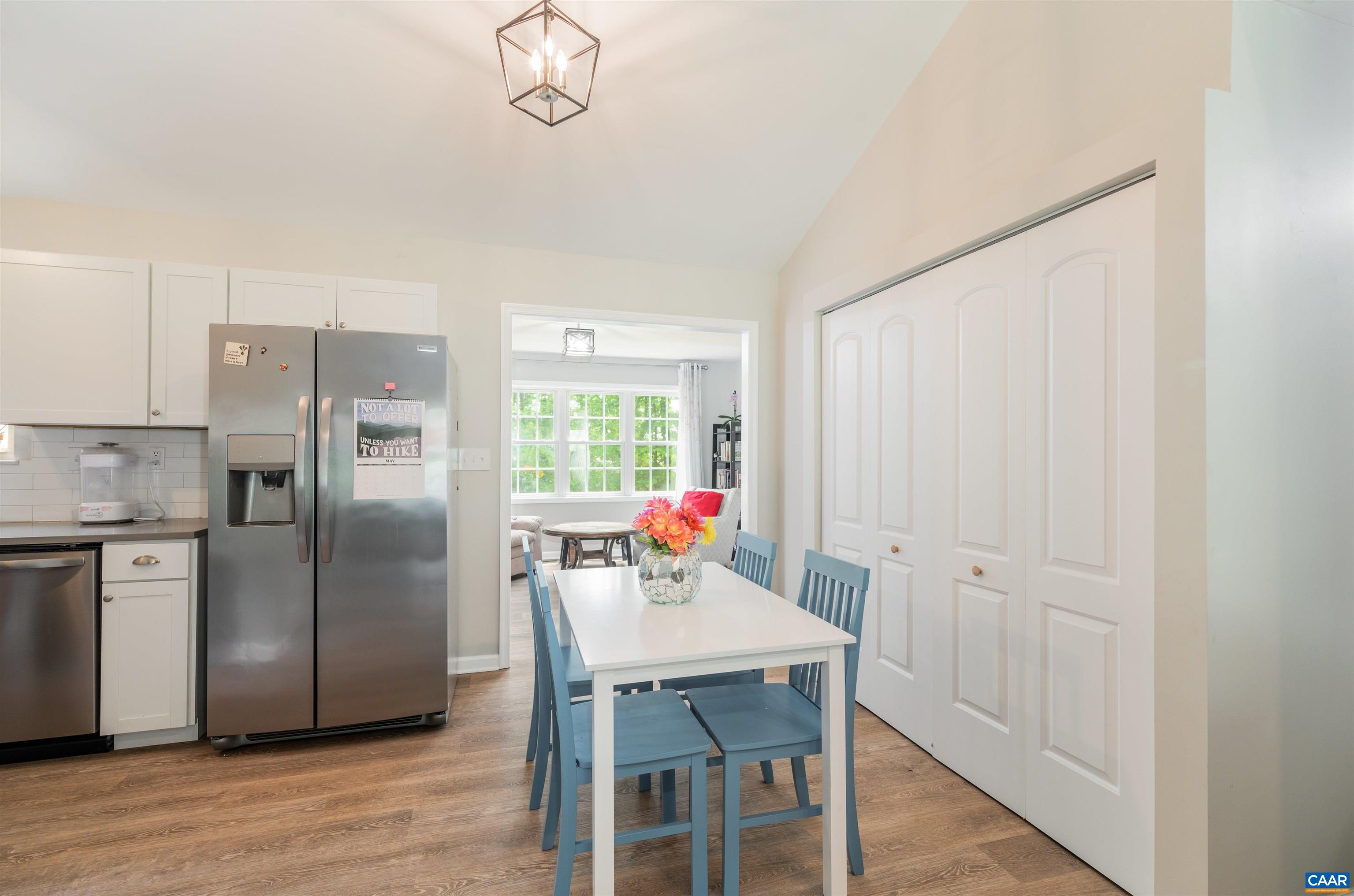 1507 Buck Road Crozet, VA 22932 - Photo 7 of 33 a kitchen with stainless steel appliances granite countertop a refrigerator a stove a sink dishwasher with a dining table and chairs