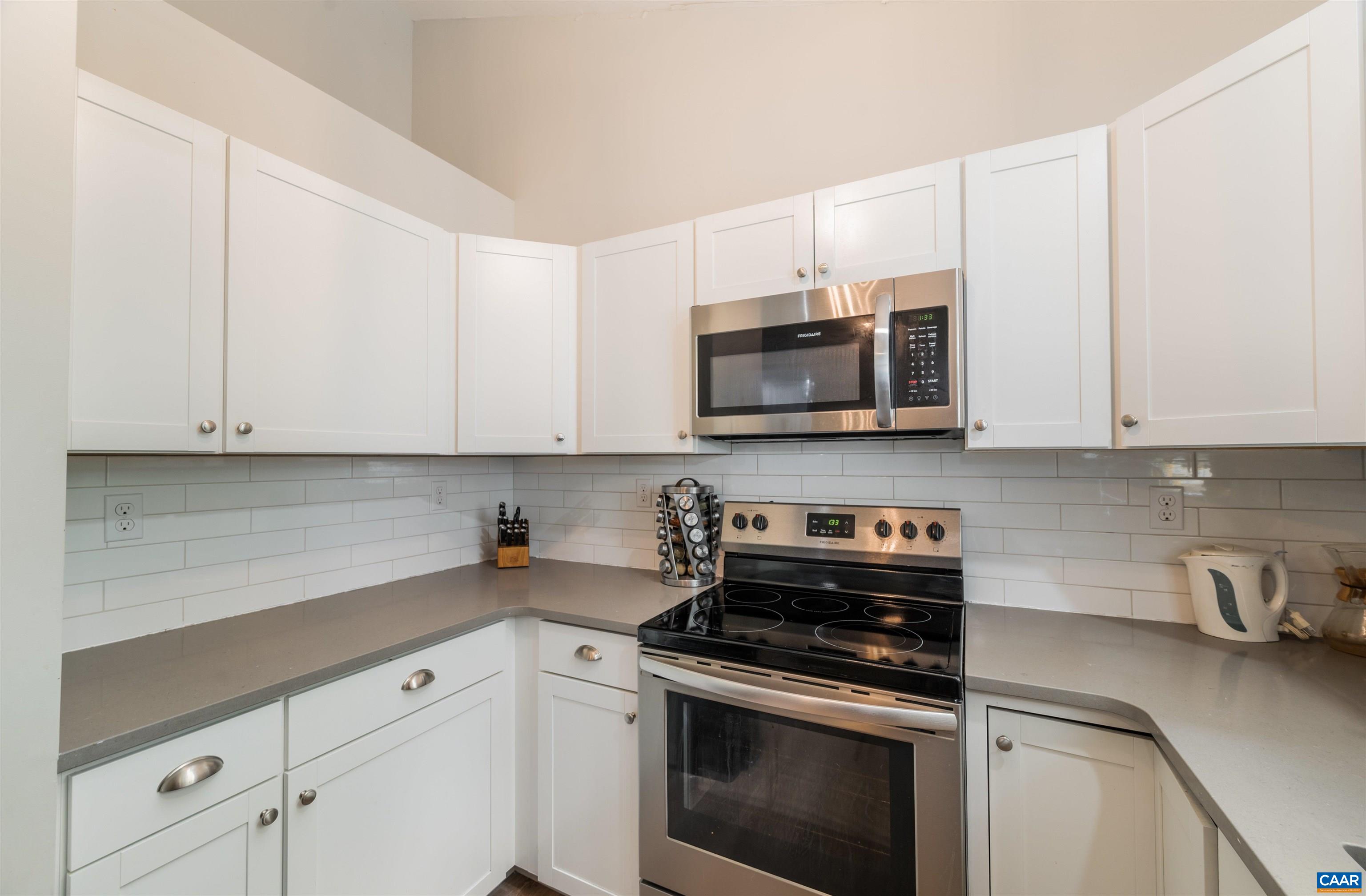 1507 Buck Road Crozet, VA 22932 - Photo 10 of 33 a kitchen with stainless steel appliances granite countertop grey cabinets a stove a sink and dishwasher