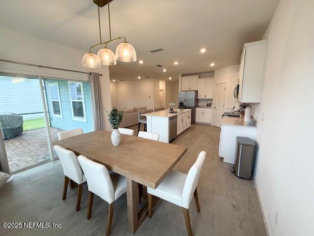 79 Beauclair Boulevard St. Augustine, FL 32084 - Photo 14 of 38 a kitchen with a dining table chairs and chandelier