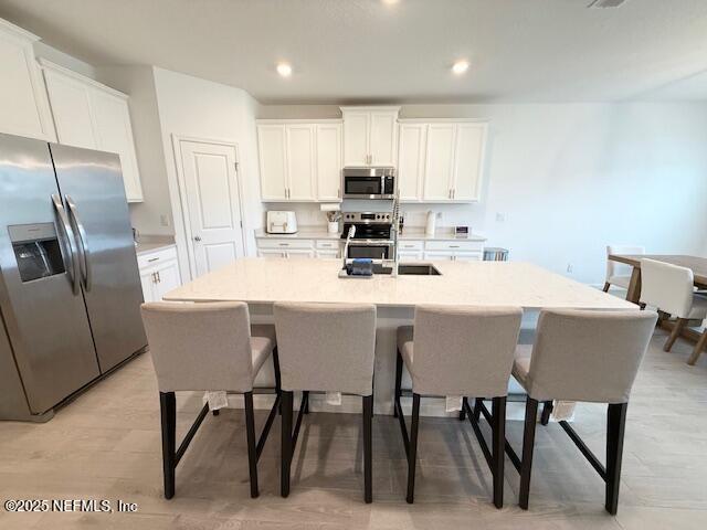 79 Beauclair Boulevard St. Augustine, FL 32084 - Photo 9 of 38 a kitchen with stainless steel appliances a table chairs microwave and sink