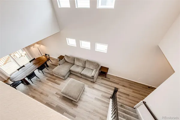 a living room with couches and a night stand