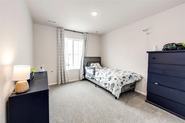 a bedroom with a bed and window