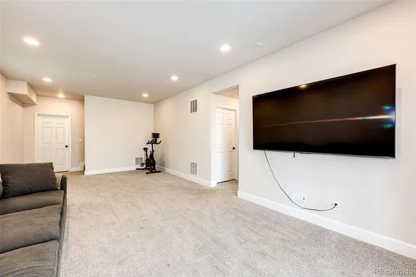 a view of a livingroom with furniture and a flat screen tv