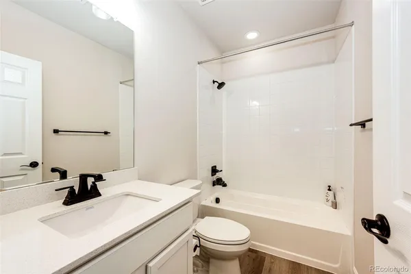 a bathroom with a sink toilet vanity and shower