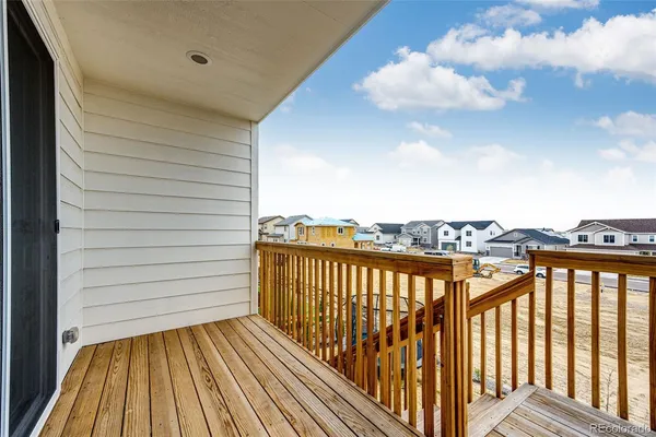 a view of a balcony with wooden floor