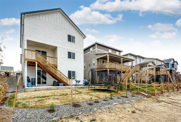 a view of a house with wooden fence