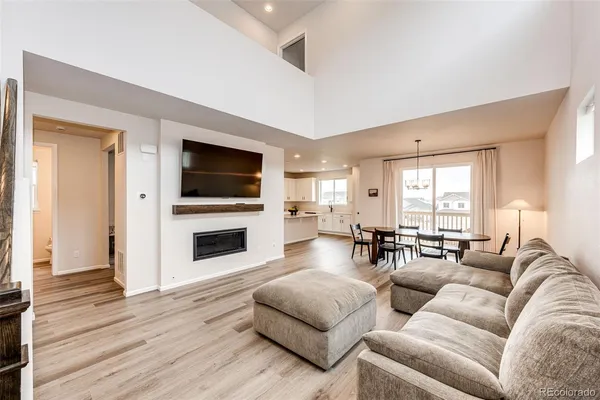 a living room with fireplace furniture and a flat screen tv
