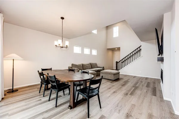 a view of a dining room with furniture wooden floor and chandelier