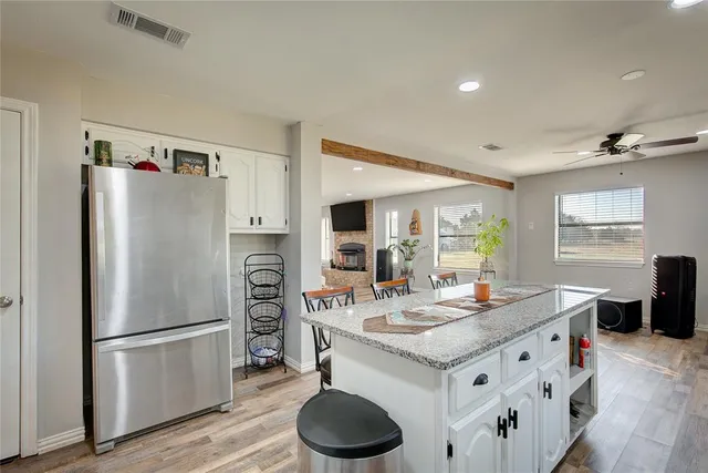 a kitchen with stainless steel appliances kitchen island granite countertop a sink stove and cabinets