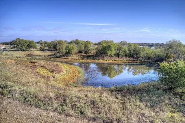 a front view of a house with a big yard