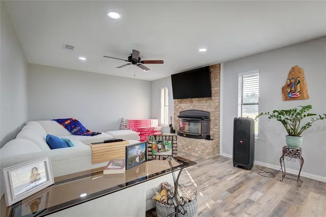 a living room with fireplace furniture and a flat screen tv