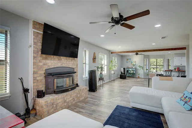 a living room with furniture a fireplace and a flat screen tv