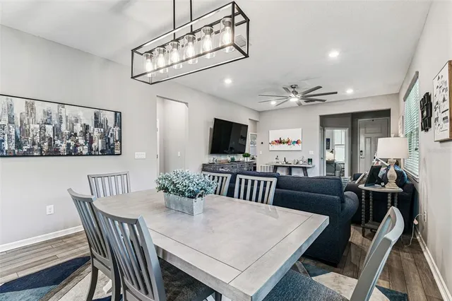 a kitchen with kitchen island a stove a table and chairs