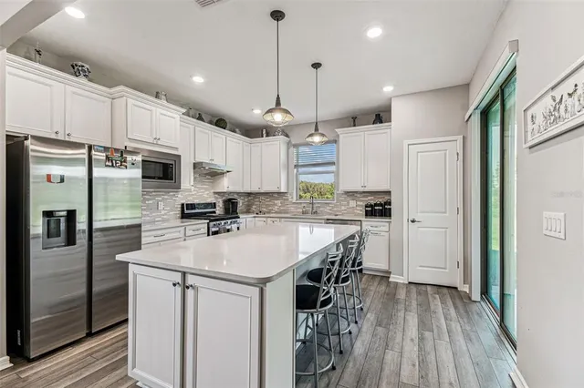 a kitchen with granite countertop a stove sink and cabinets
