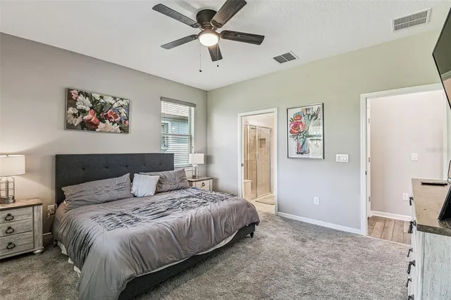 a bedroom with a bed and a painting on the wall