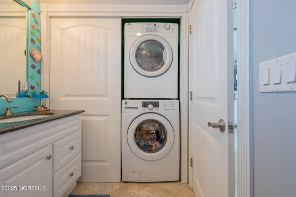 a utility room with sink dryer and washer