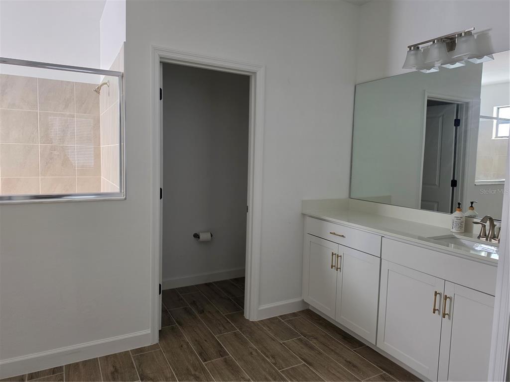18334 Ridgeline Drive Estero, FL 33928 - Photo 11 of 30 a spacious bathroom with a double vanity sink and a mirror