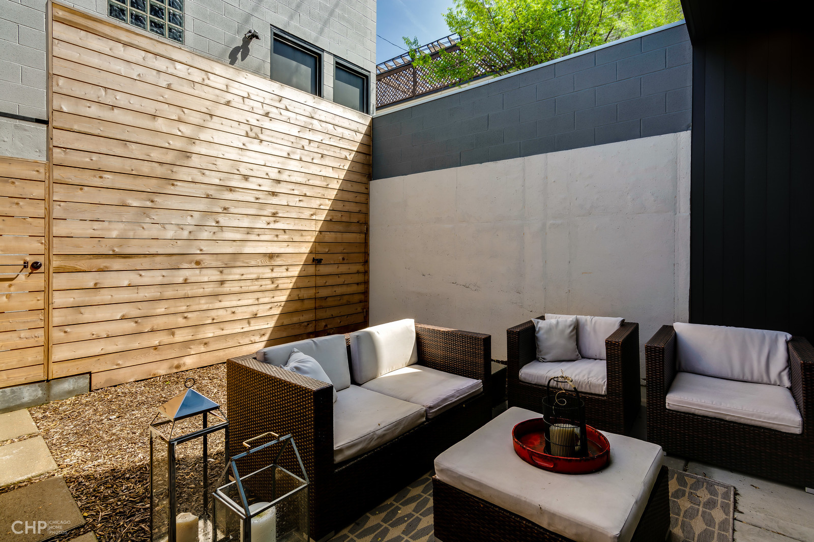 2016 West Rice Street, Unit 101 Chicago, IL 60622 - Photo 14 of 17 a balcony with a couch and a potted plant