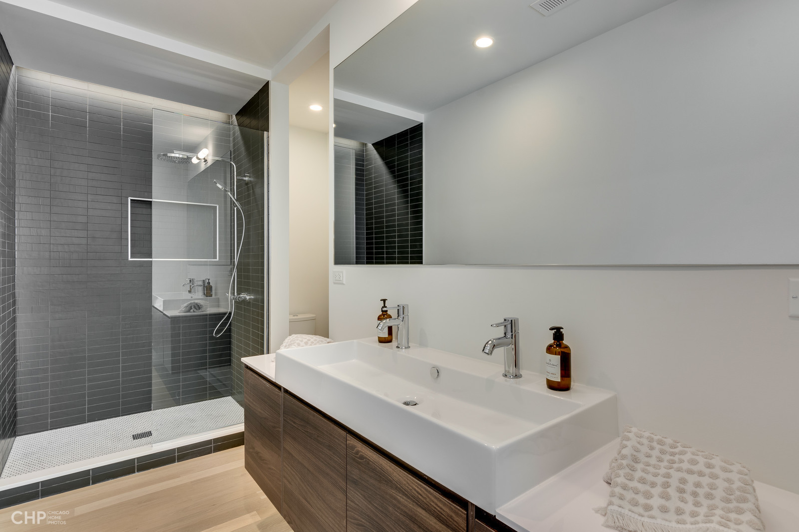 2016 West Rice Street, Unit 101 Chicago, IL 60622 - Photo 8 of 17 a bathroom with a sink a toilet and shower