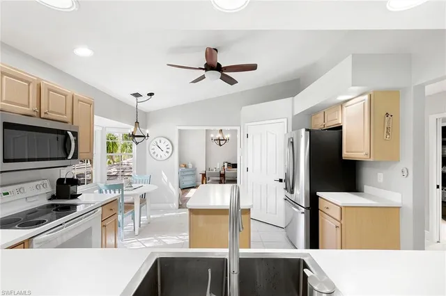 a living room with furniture a large window and a flat screen tv
