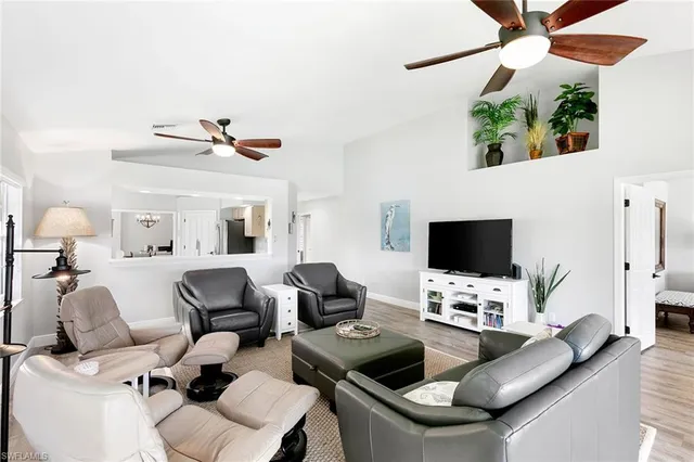 a bedroom with a large bed and flat tv screen on dresser
