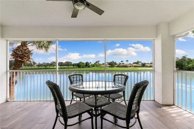 a view of a porch with furniture and a yard