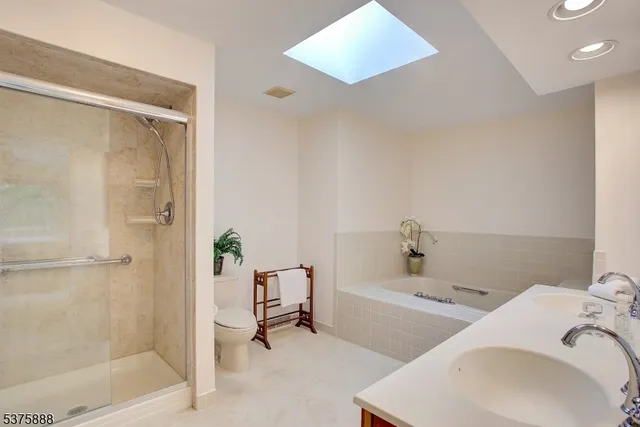 a bedroom with a bed table and a window