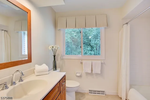 a balcony with wooden floor and outdoor seating