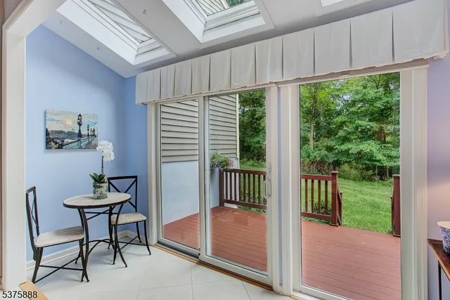 a dining room with furniture a chandelier and wooden floor
