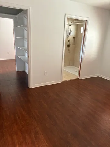 a bathroom with a granite countertop sink and a toilet