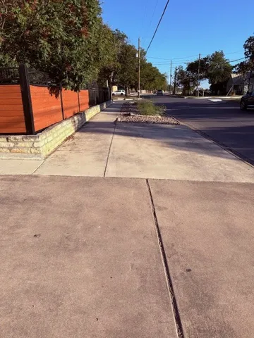 a view of a small space with wooden fence