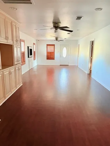 a view of a kitchen with a sink and a refrigerator