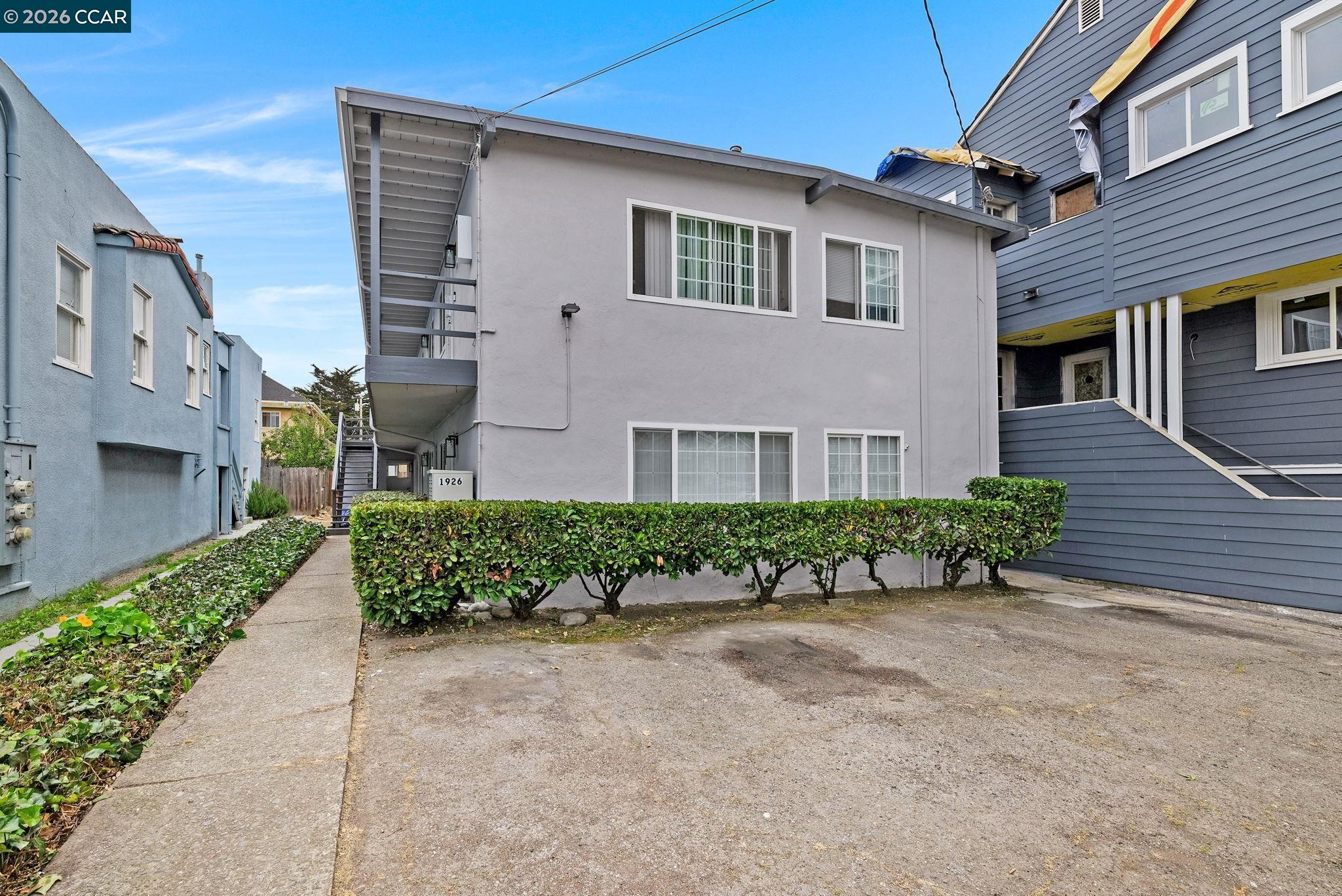 1926 Alcatraz Avenue, Unit 2 Berkeley, CA 94703 - Photo 2 of 13 a front view of a house with a yard